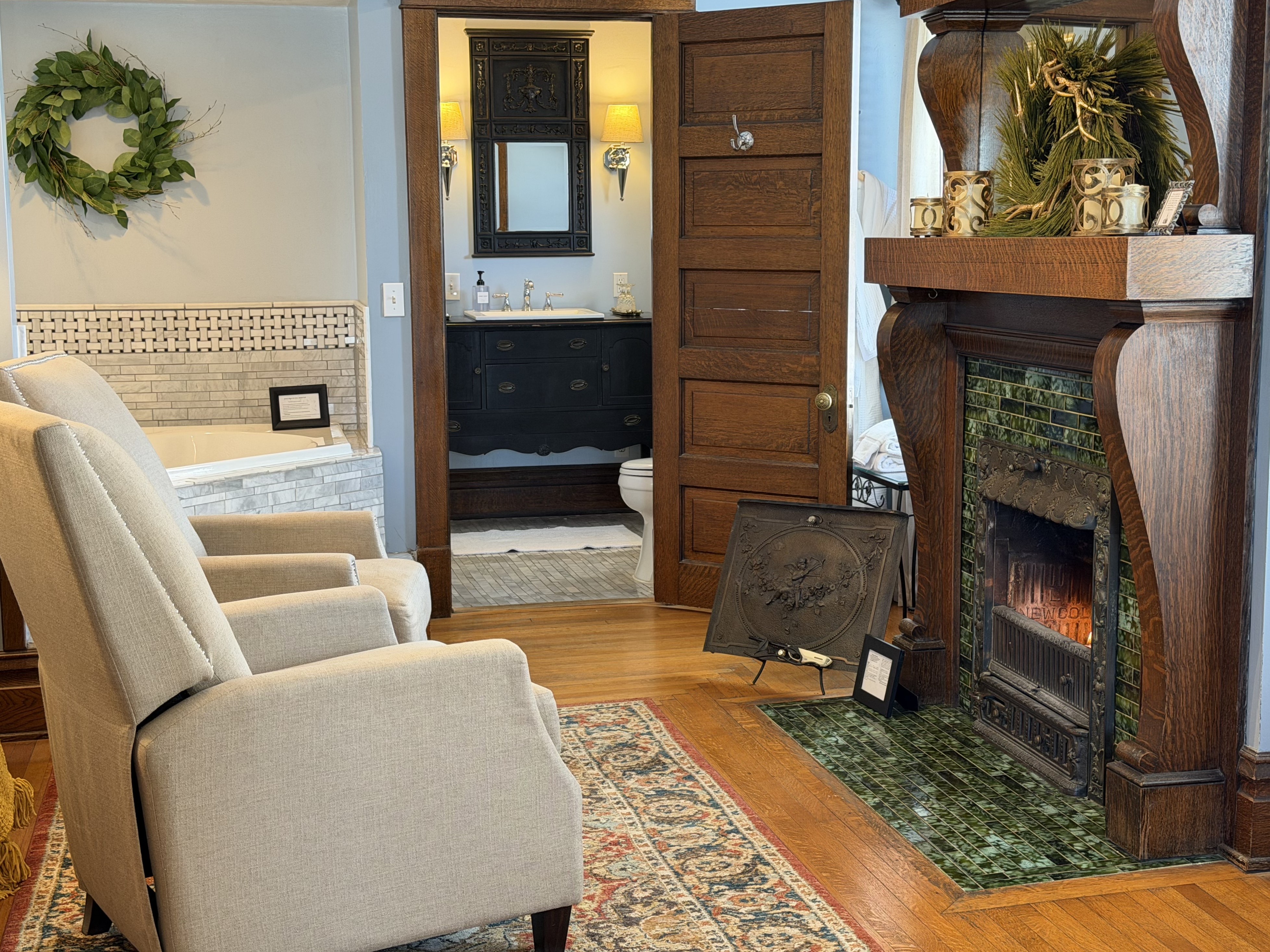Suite Sitting area with fireplace, chairs, 2 person jetted tub, ensuite bath