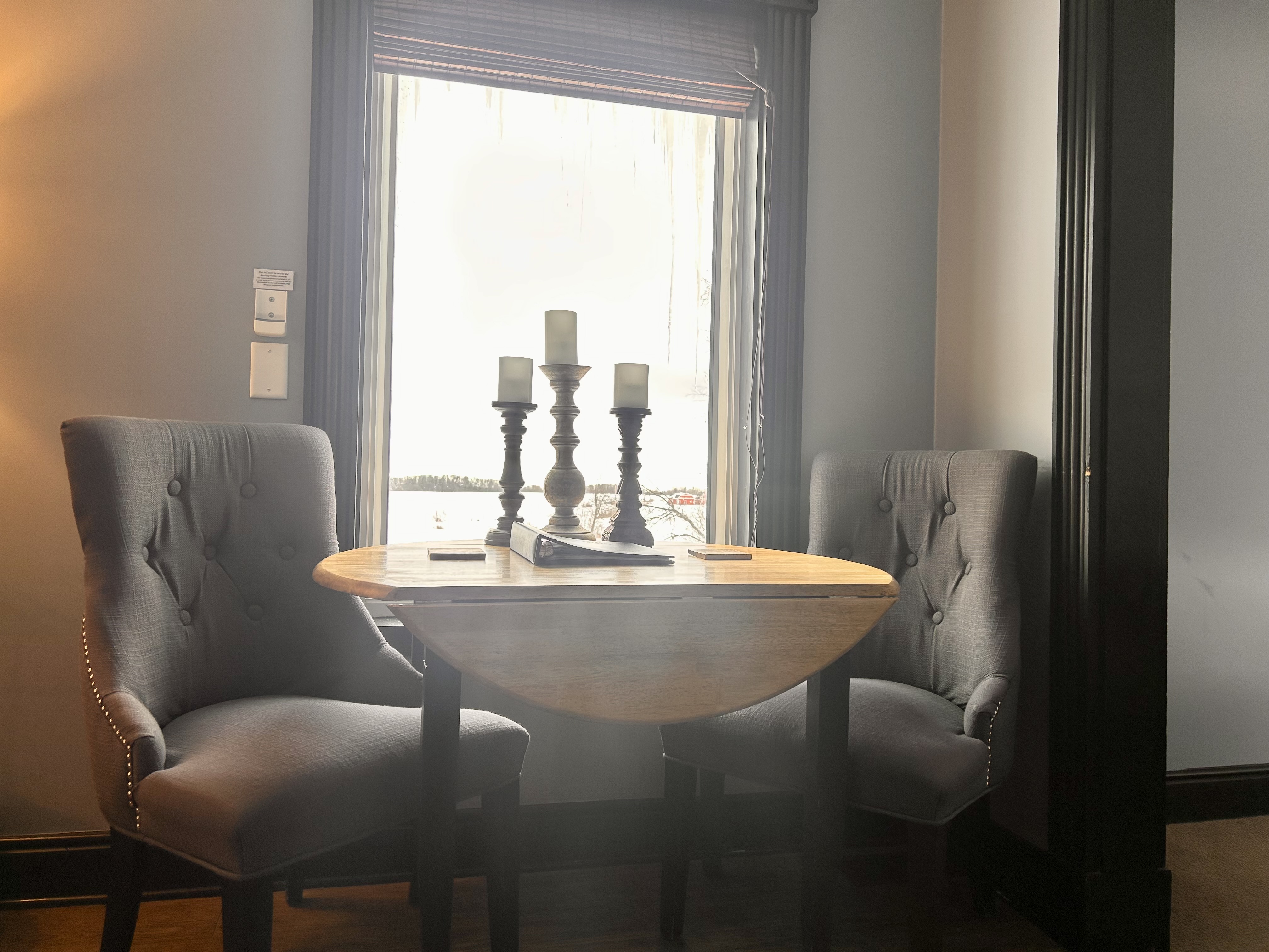 Suite with seating area and window overlooking a pond