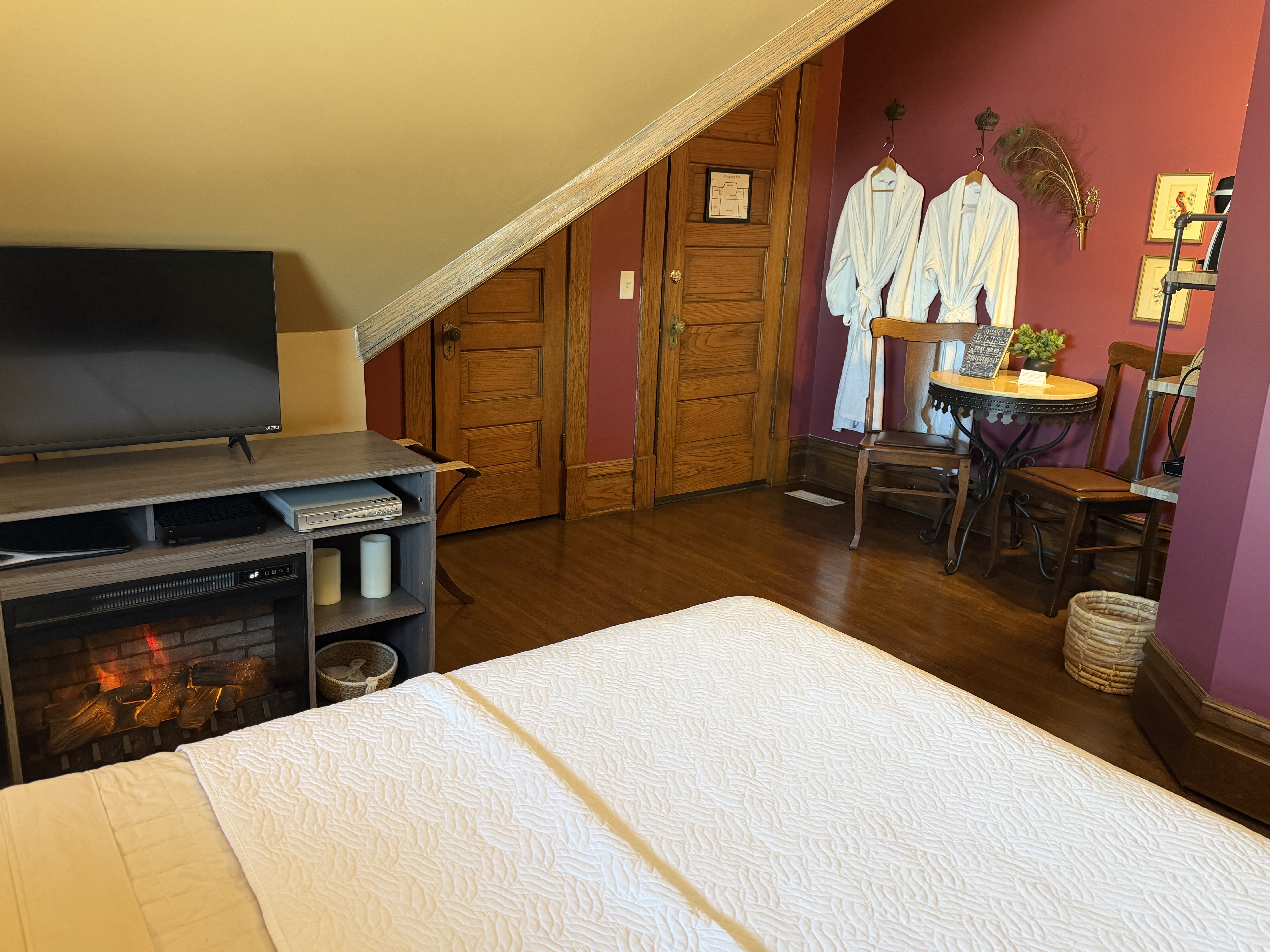 Room with table/chairs, queen bed and ensuite bath