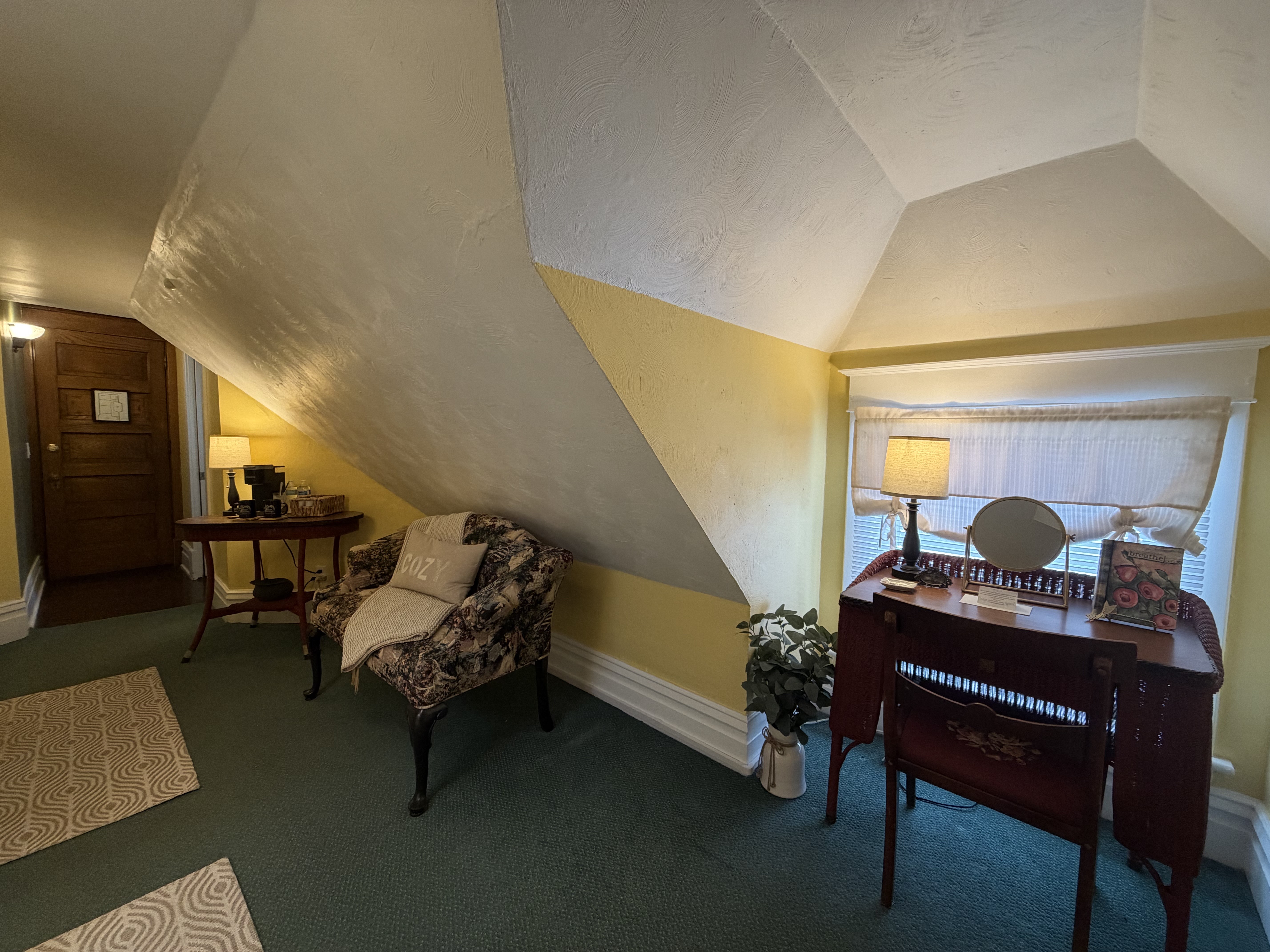 Desk with lamp, mirror, and room diary