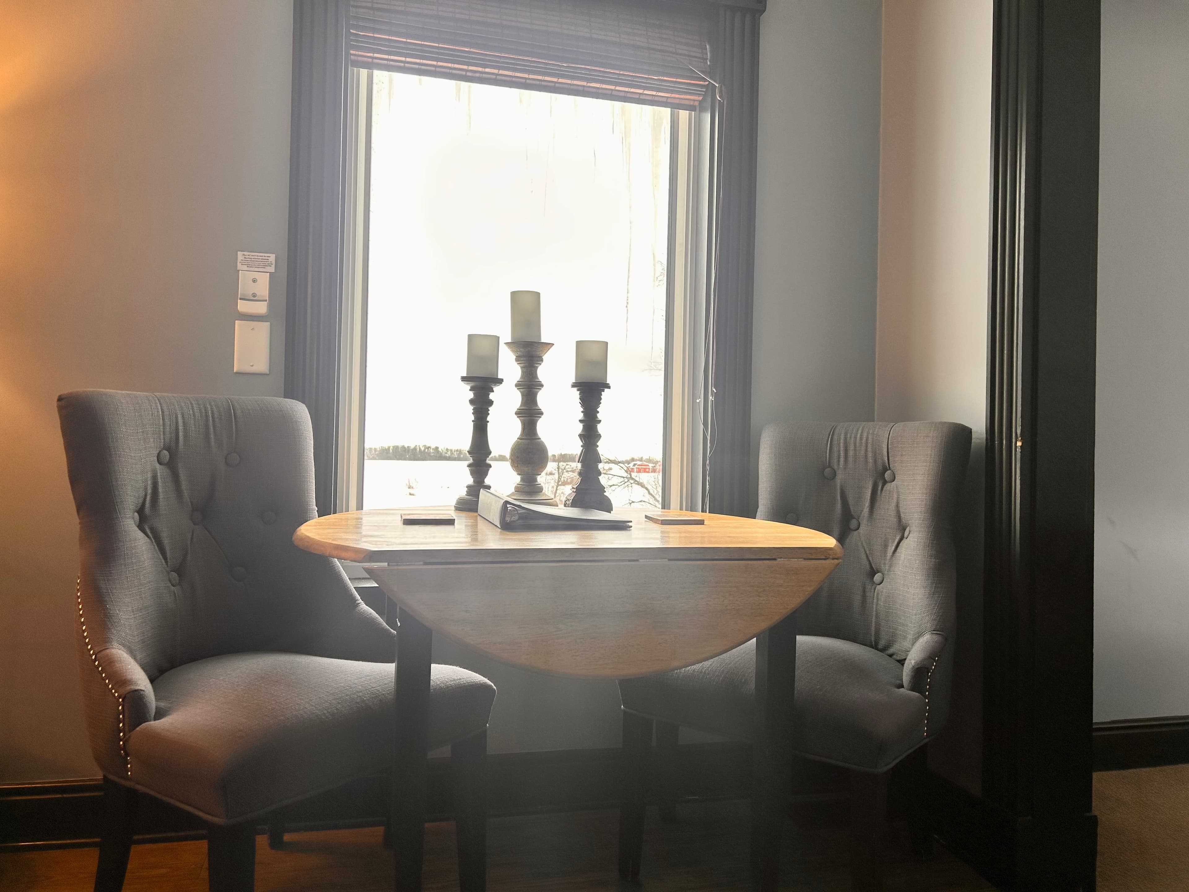 Suite with seating area and window overlooking a pond