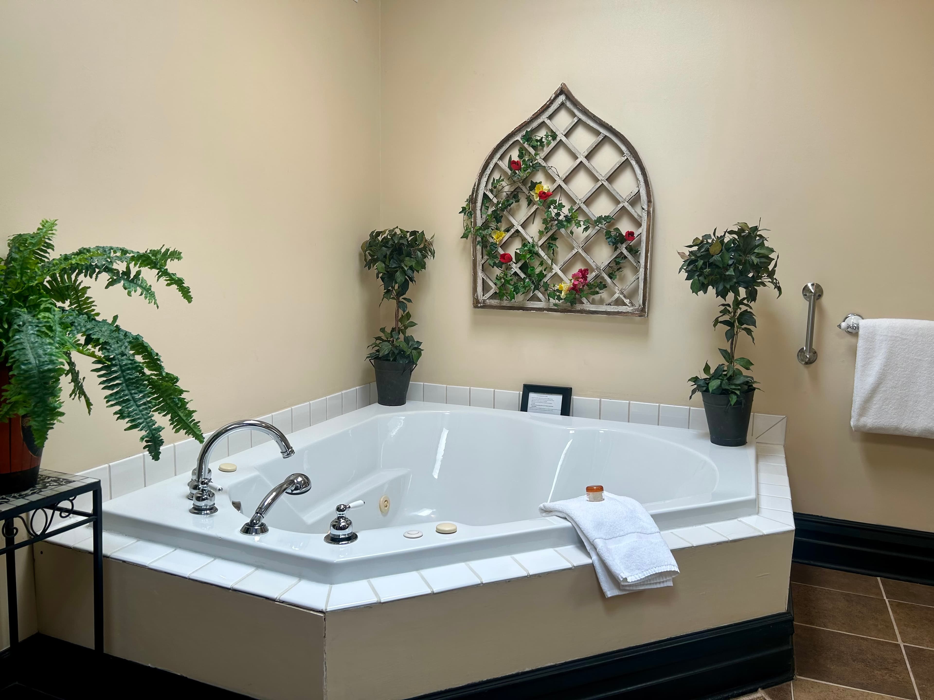 Suite with king bed, seating area, through french doors ensuite bath with two person jetted tub