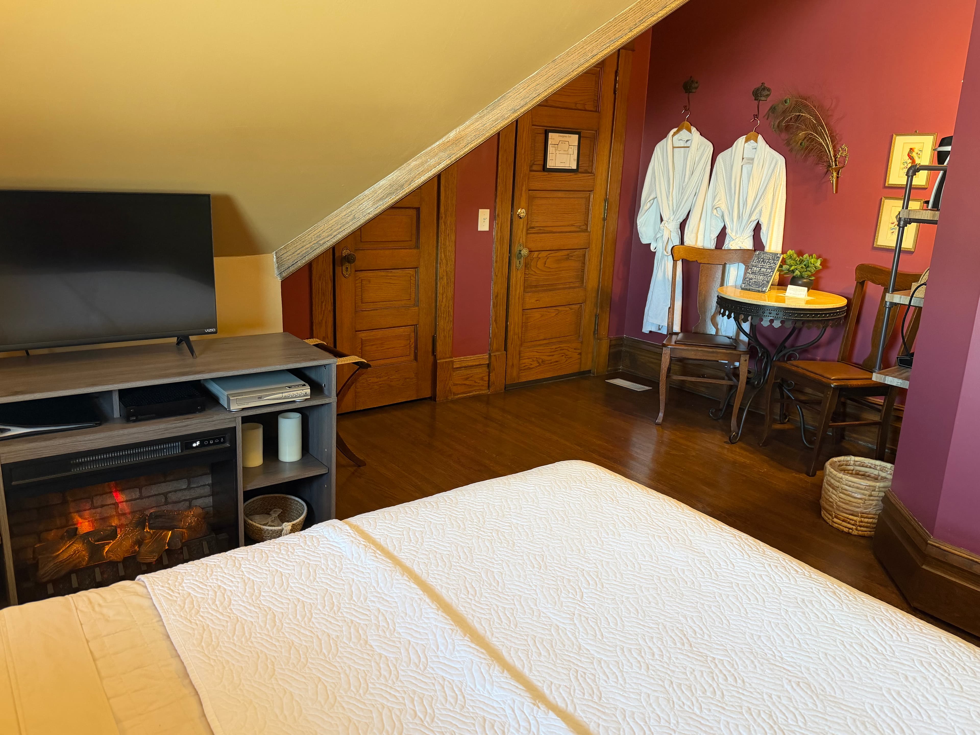 Room with table/chairs, queen bed and ensuite bath