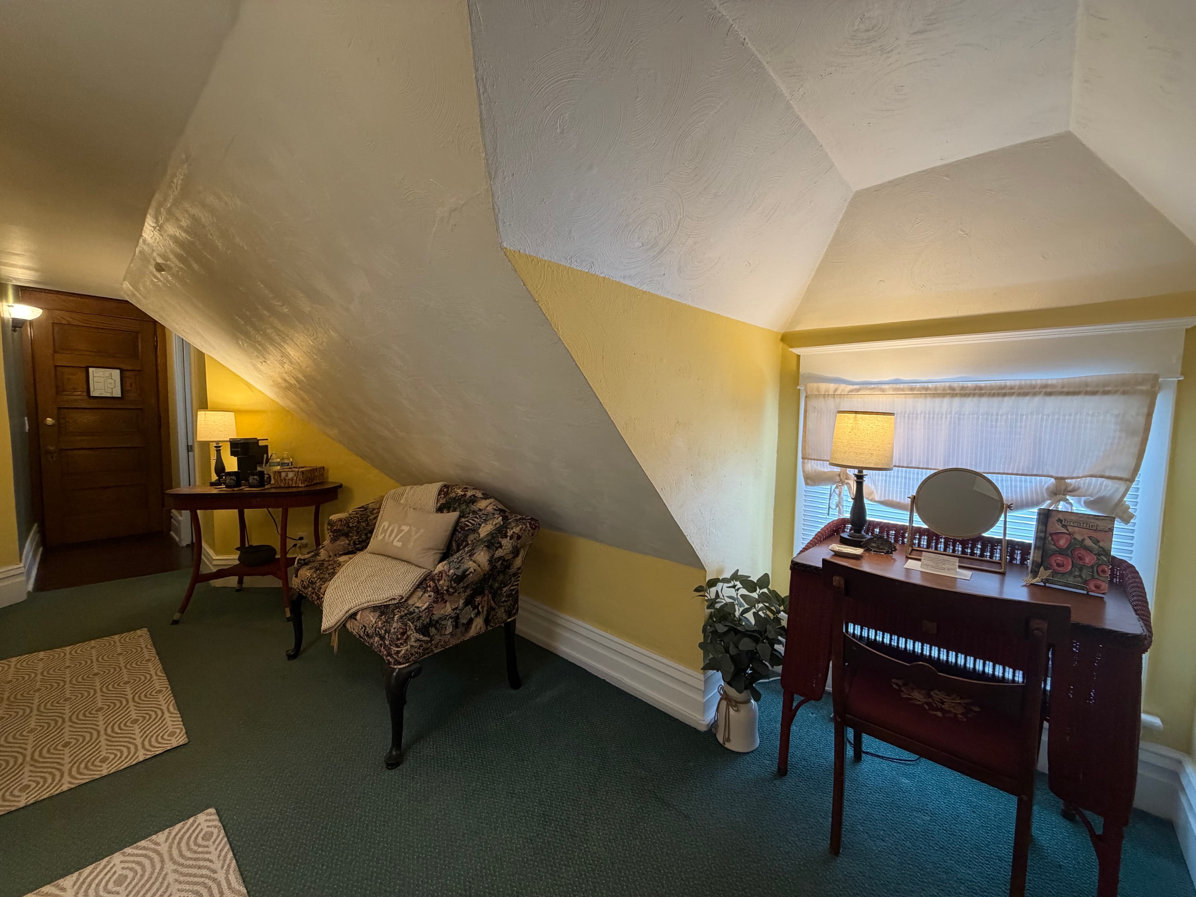 Desk with lamp, mirror, and room diary