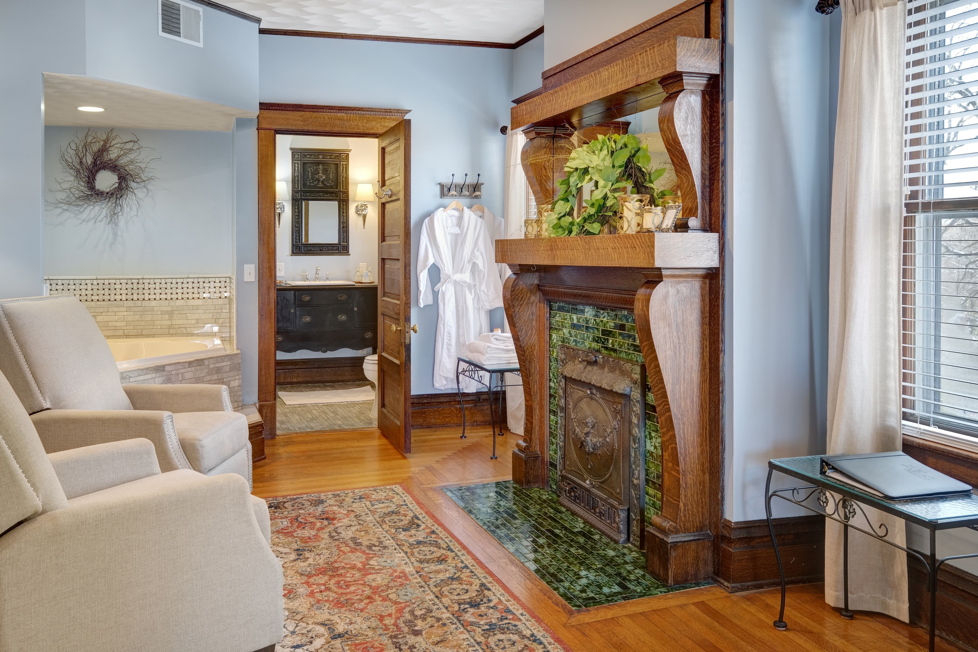 Suite Sitting area with fireplace, chairs, 2 person jetted tub, ensuite bath