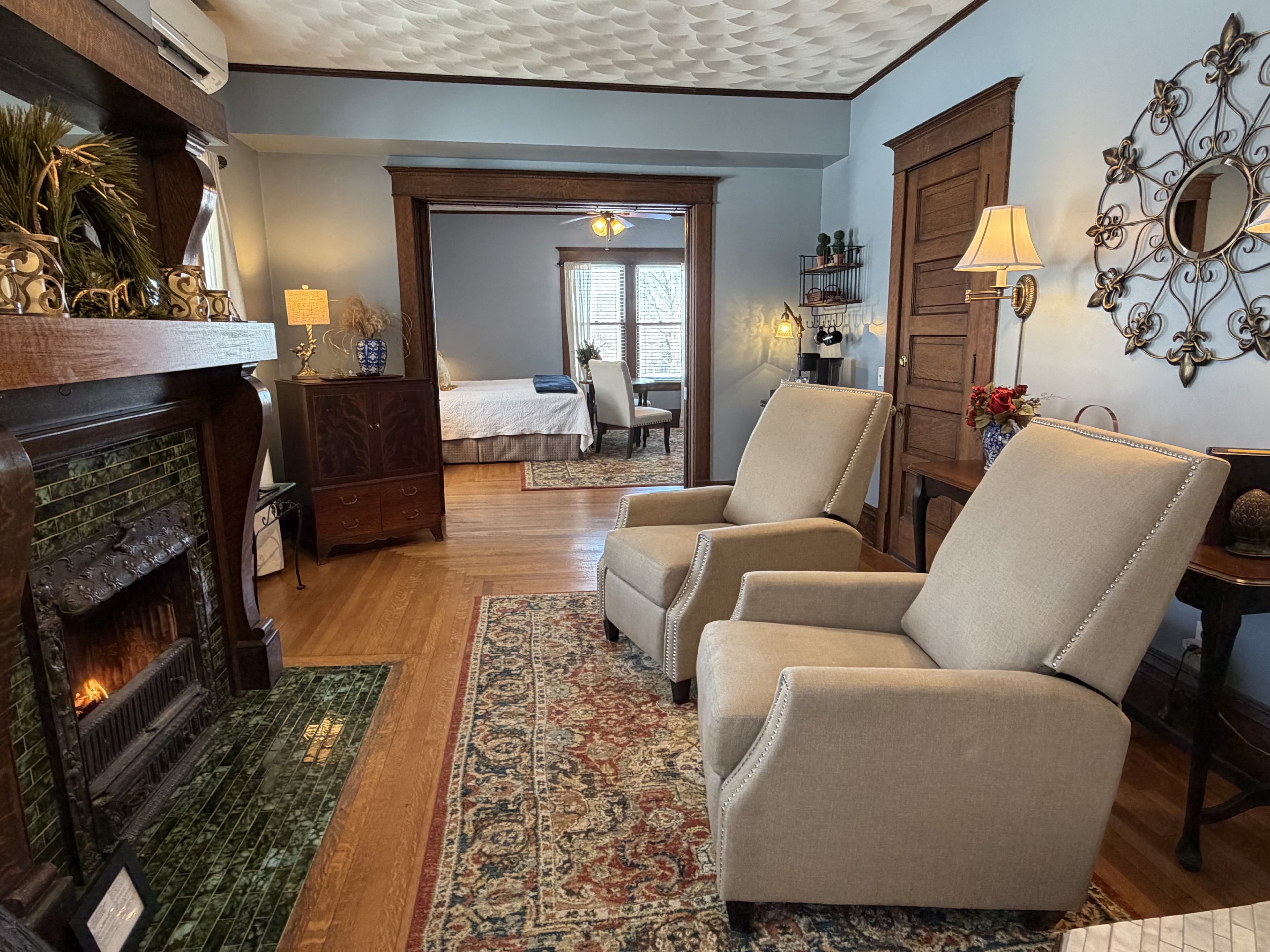 Suite with a two person jetted tub, chairs, fireplace, robes, ensuite bath