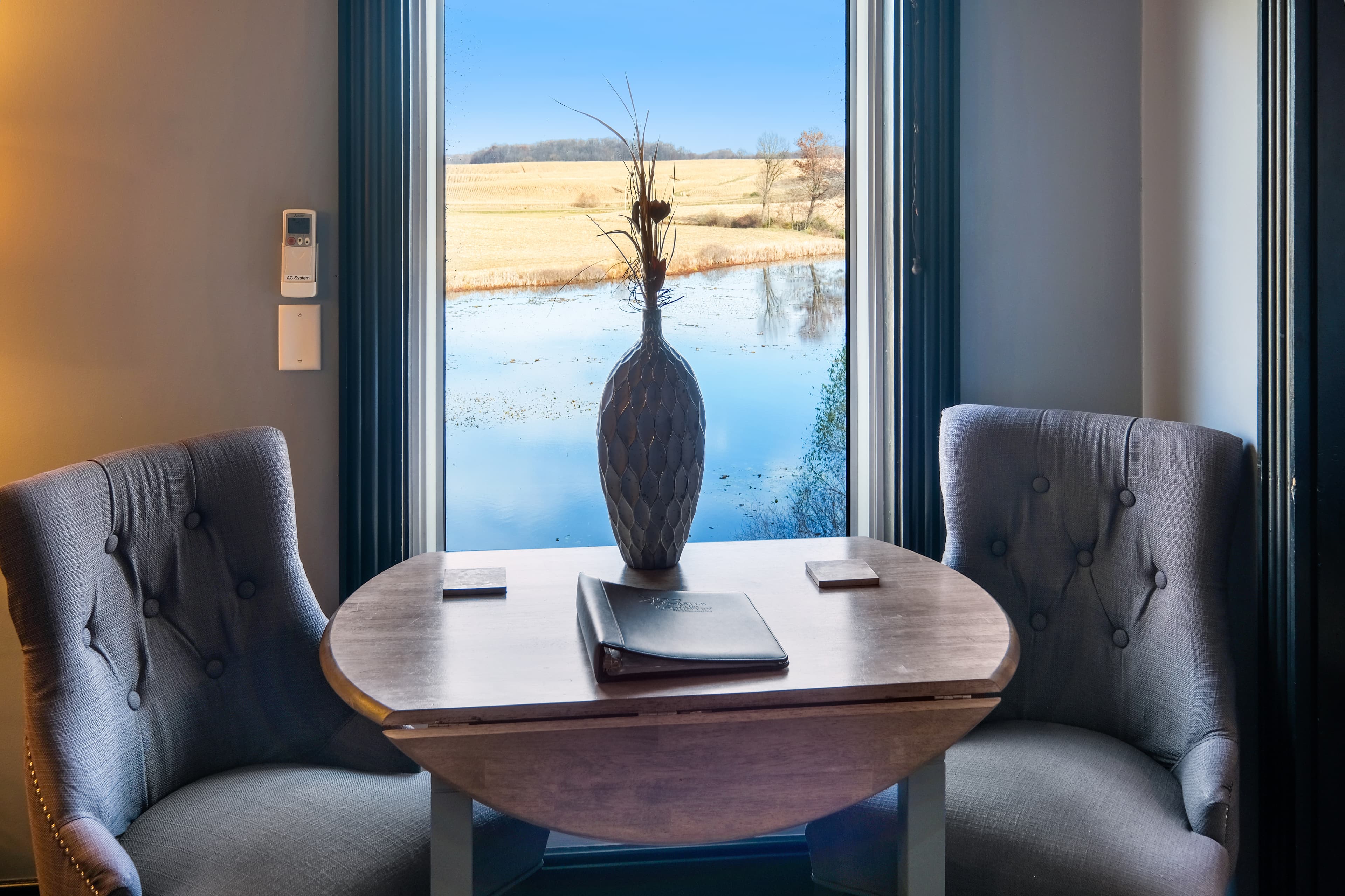 Suite with seating area and window overlooking a pond