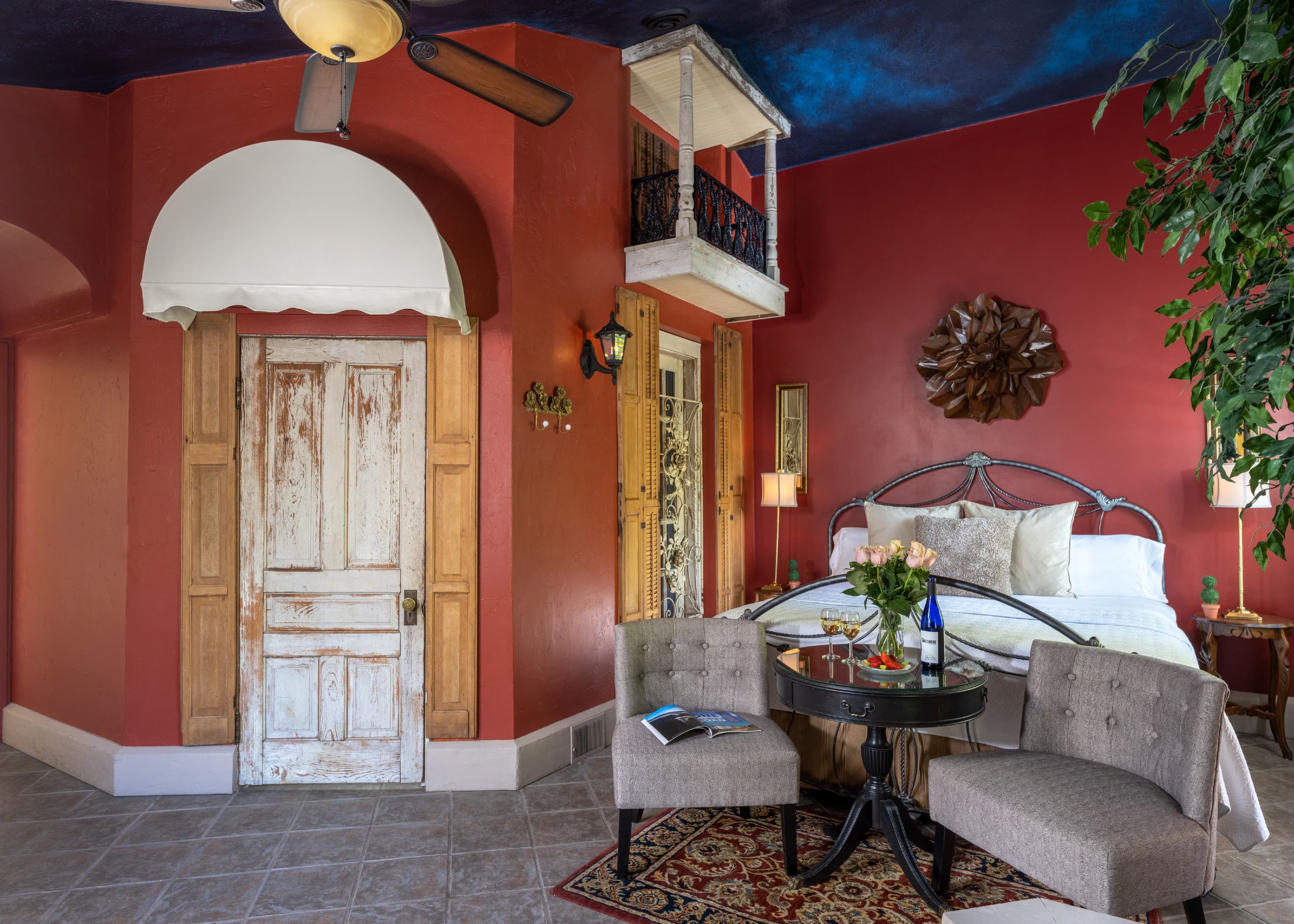 Suite with king bed, balcony, seating area with cathedral ceiling and ensuite bath