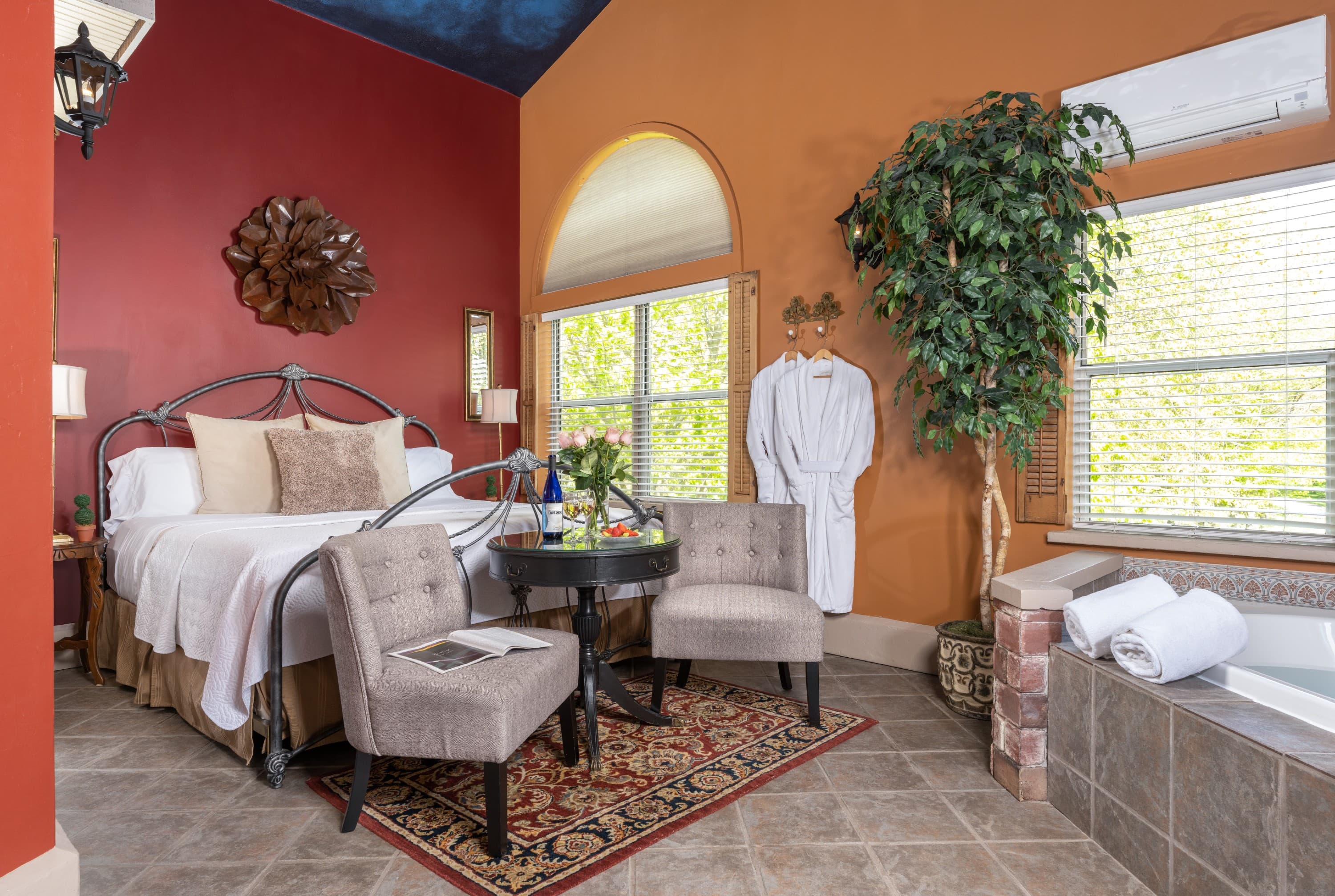 Suite with a king bed, seating area, 2 person jetted tub.