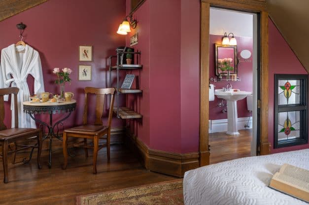 Room with table/chairs, queen bed and ensuite bath