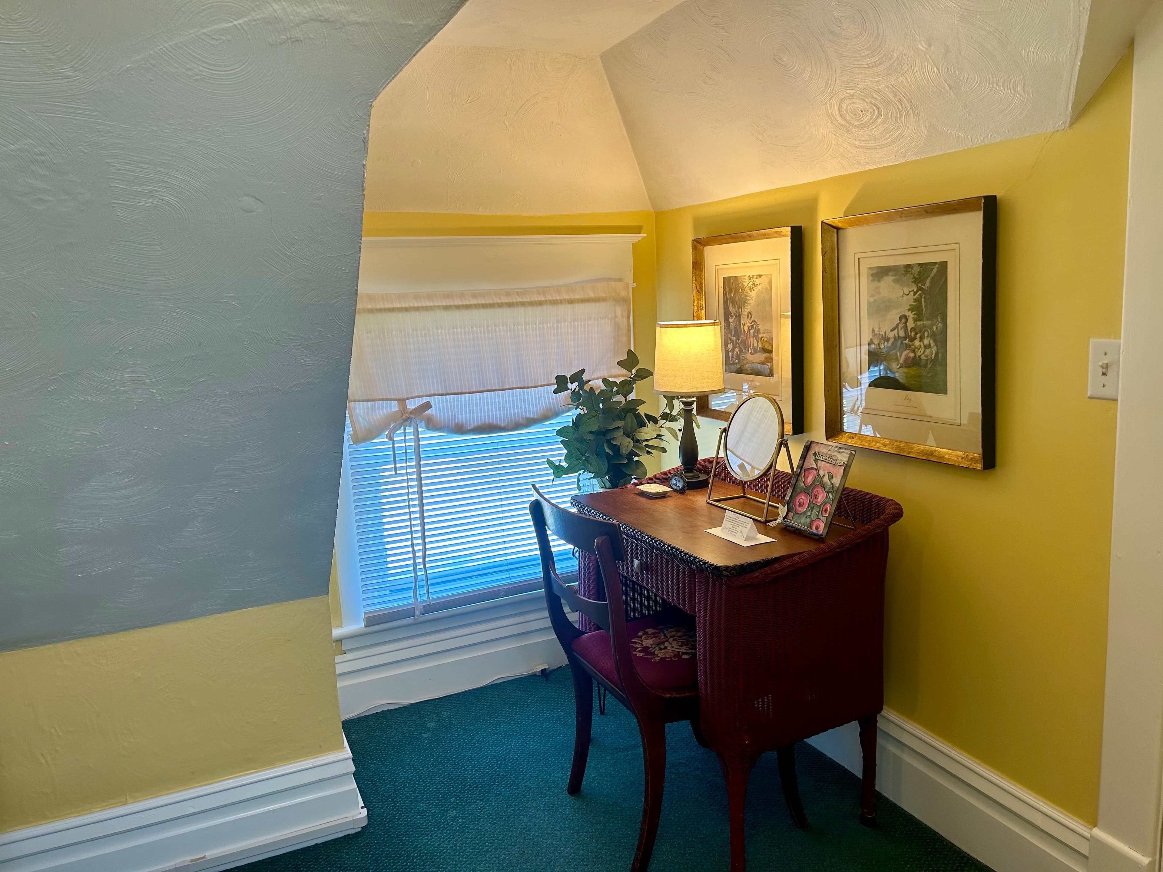 Desk with lamp, mirror, and room diary