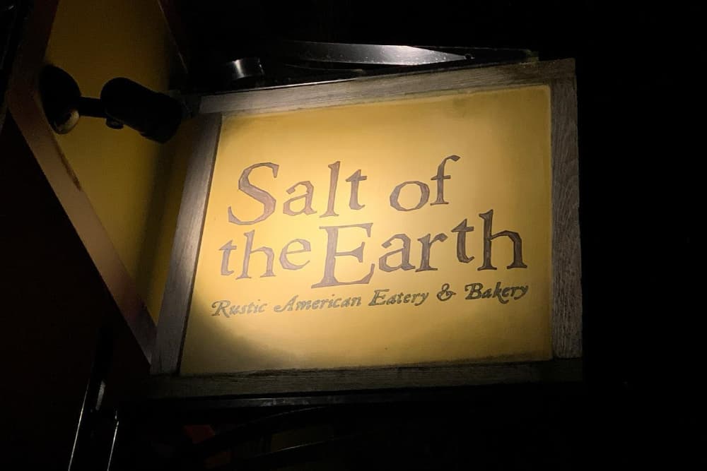 Sign for "Salt of the Earth," a rustic American eatery and bakery.