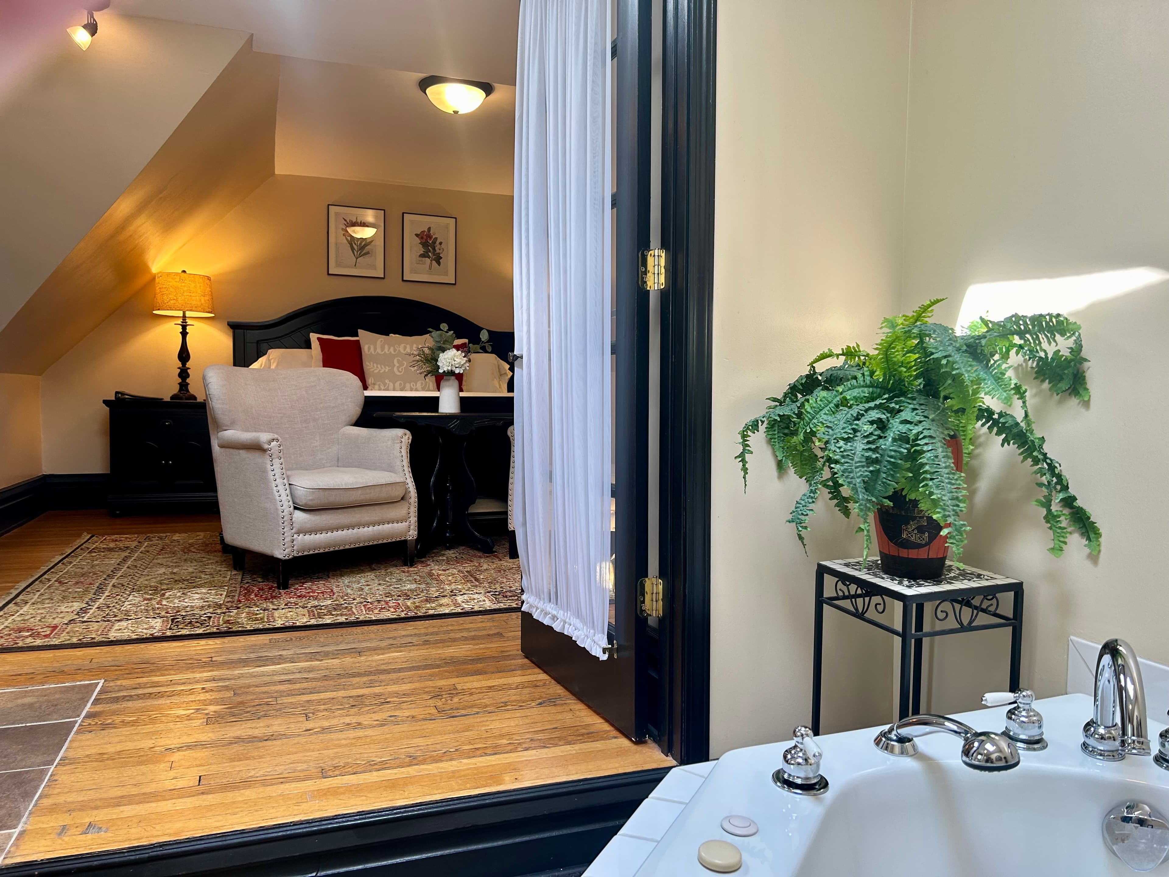 Suite with king bed, seating area, french doors to ensuite bath with 2 person jetted tub