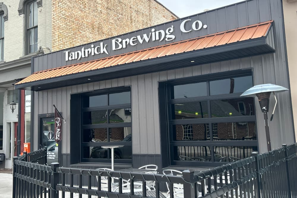 Exterior view of Tantrick Brewing Co. featuring large windows and an "Open" sign.