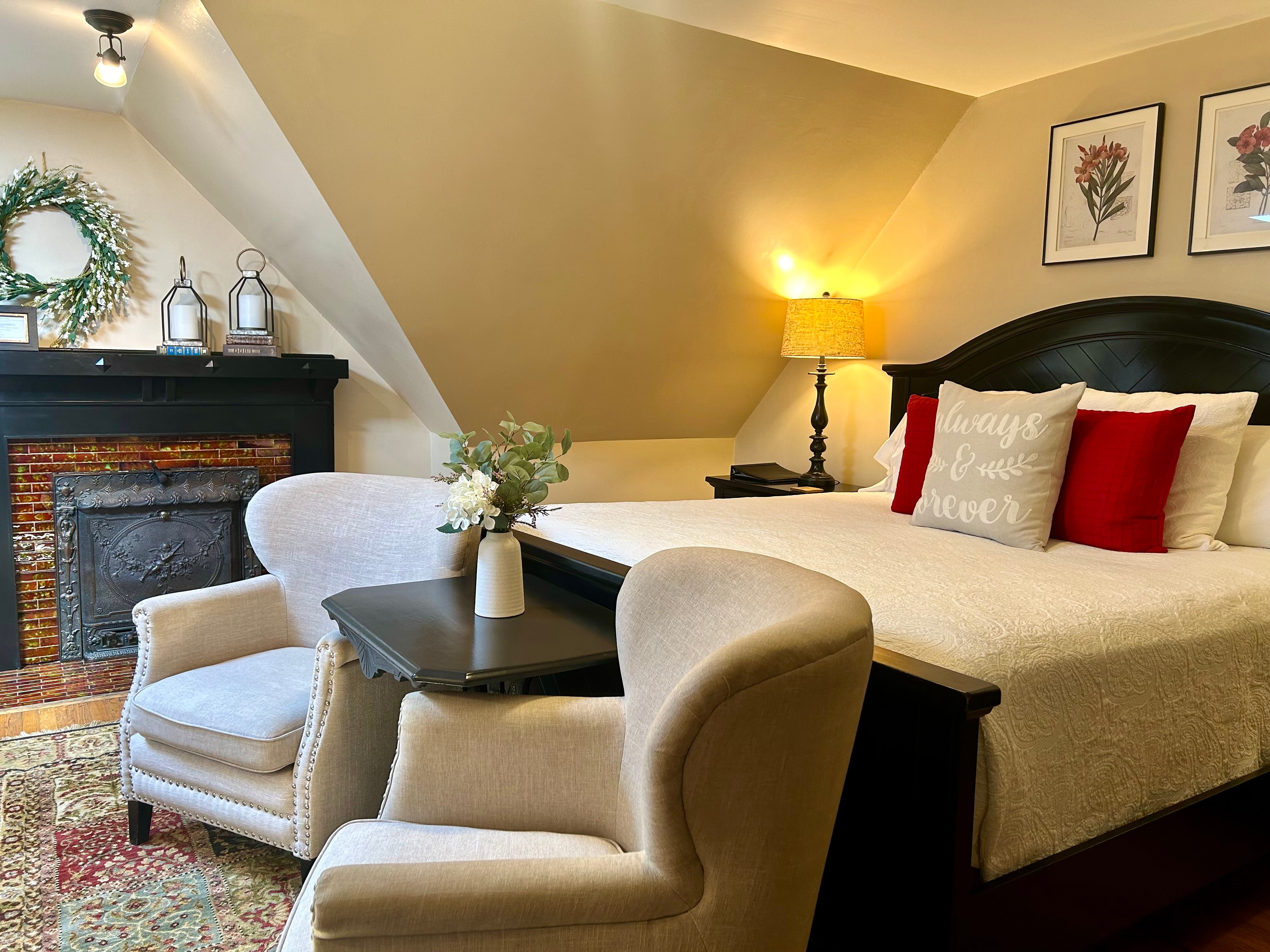 Suite with king bed, seating area, and wood burning fireplace