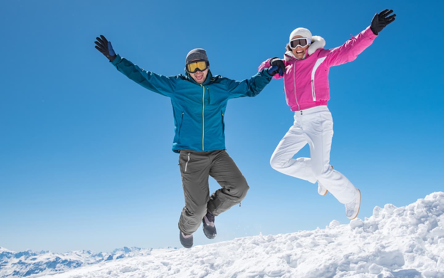 Young couple playing with snow outdoor in a winter day. Happy wo Young couple playing with snow outdoor in a winter day. Happy wo