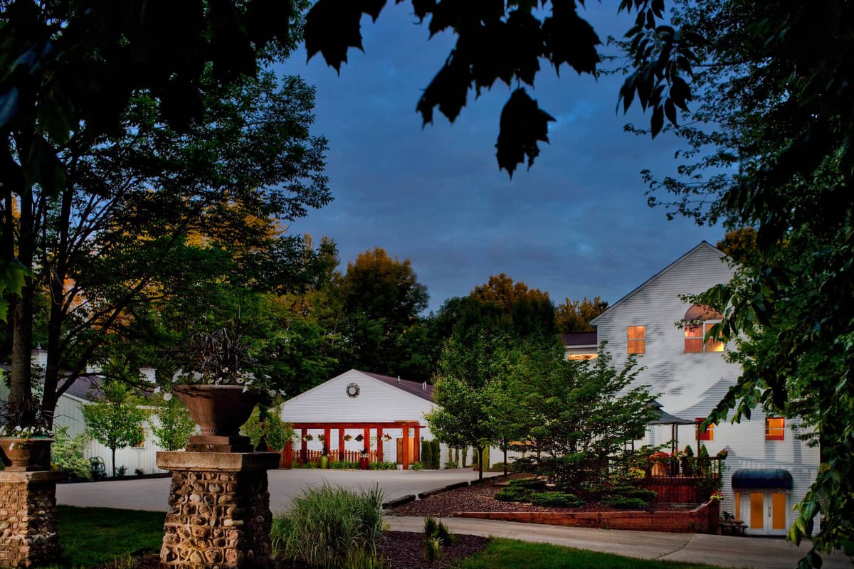 Castle Keep building at dusk surrounded by leafy trees