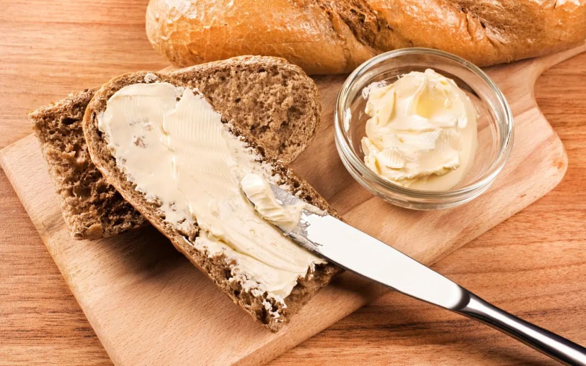 Wood cutting board with fresh bread and butter
