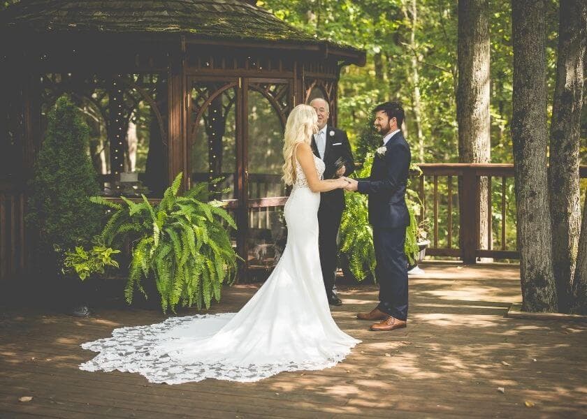 bridal couple standing outside gazebo during bridal ceremony bridal couple standing outside gazebo during bridal ceremony