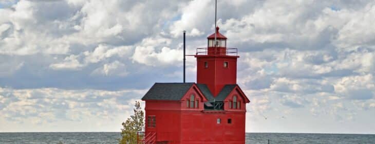 the iconic big red lighthouse on the shore of holland, michigan