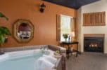 Two person whirlpool tub with a view of the fireplace.