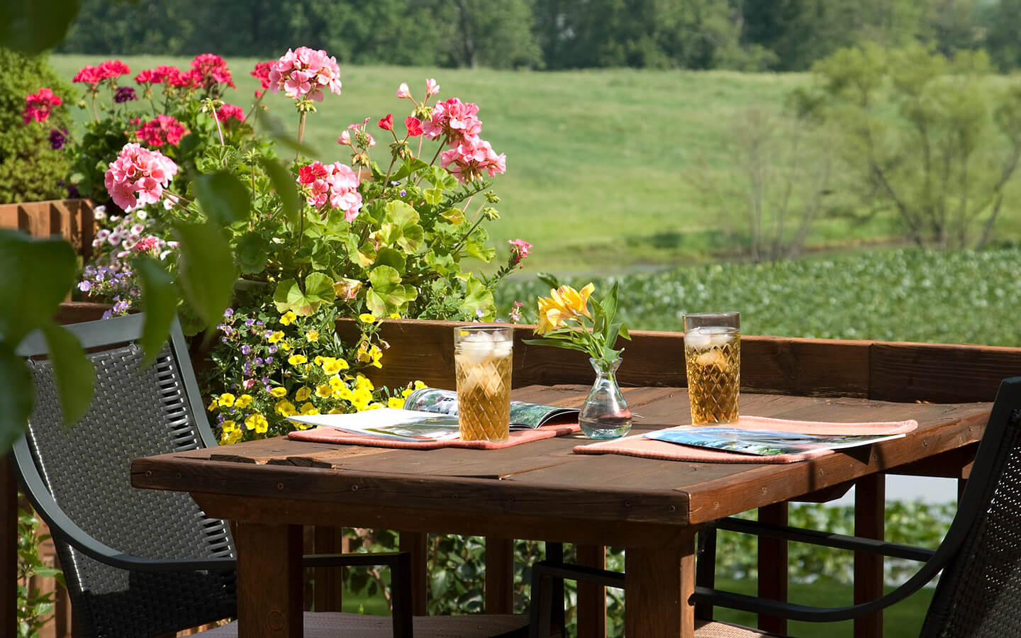 Cold drinks on deck table with flowers