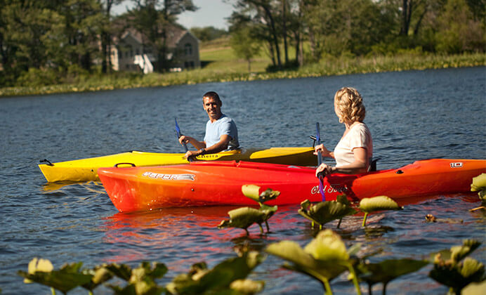 Couple on the lake in two kayaks