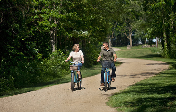 Couple riding bikes on path