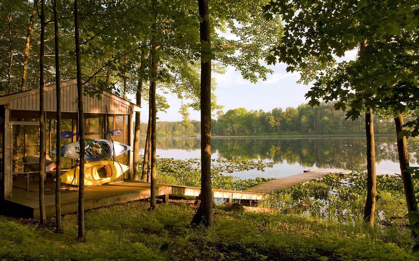 Screen house by a private lake with dock and kayaks