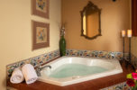 Two person whirlpool tub with a terracotta roof feature.