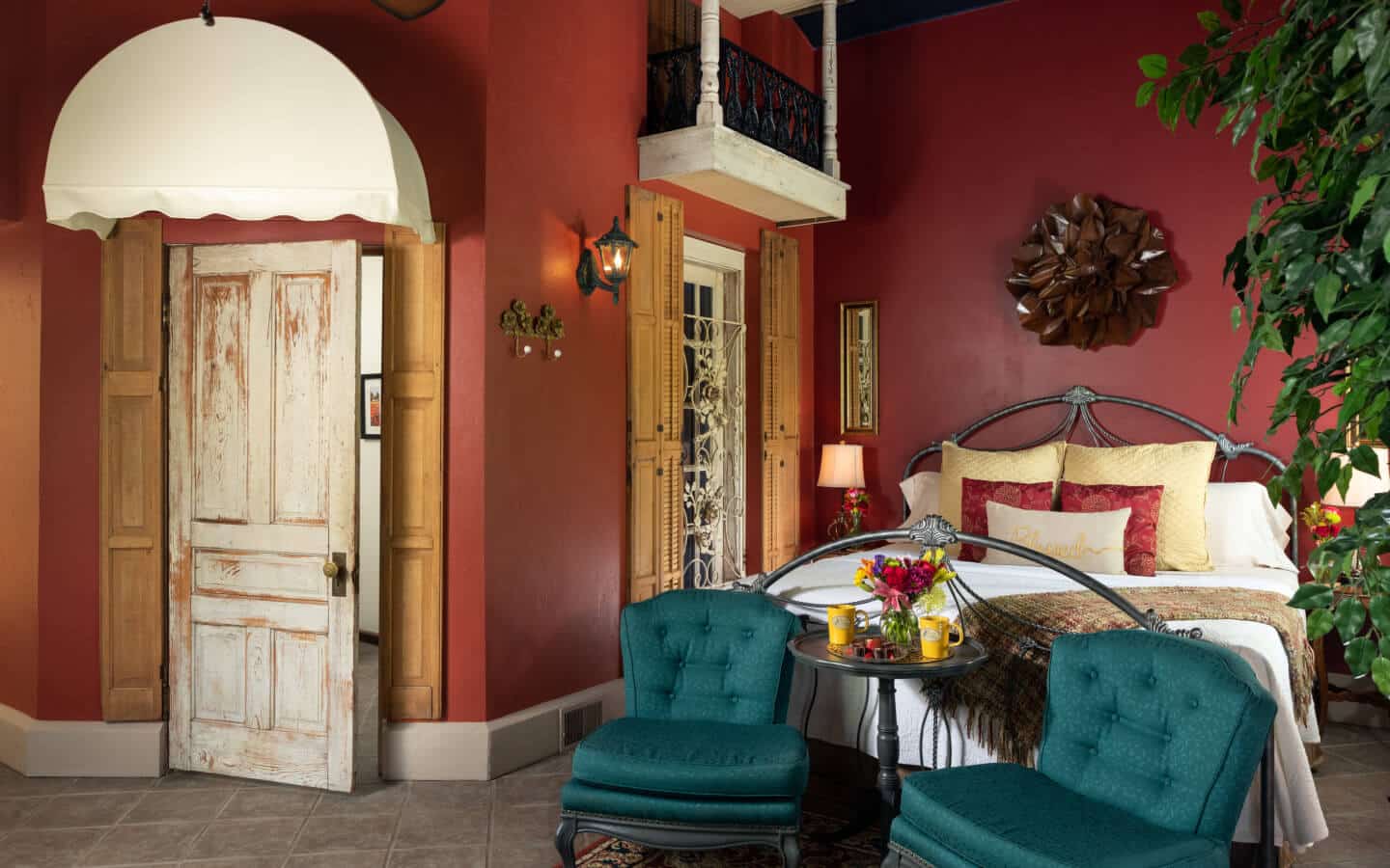 Romeo & Juliet Suite with deep muted red walls and a king-size bed
