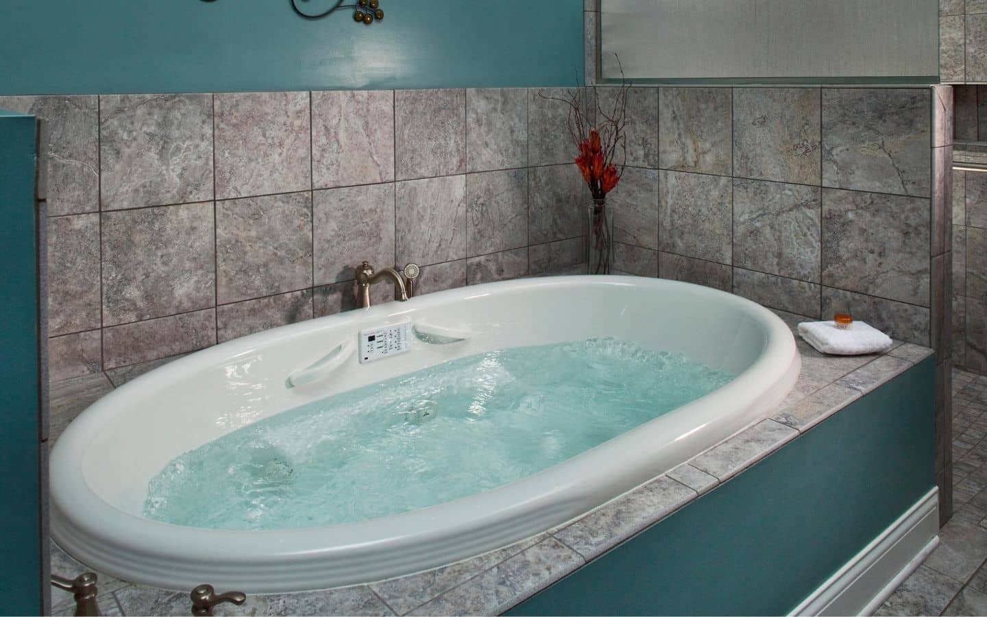 Guest bath with jets, aqua walls with tile and room for two