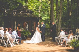 wedding ceremony on gazebo deck in summer with guests