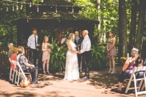 wedding ceremony with guests on gazebo deck